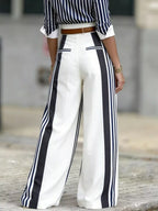 High-waisted wide-leg striped pants by Shopimist displayed on a model, featuring bold horizontal stripes and a relaxed fit.