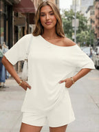 Plus size women's boat neck T-shirt and shorts lounge set by Trendsi, soft fabric, casual fit, perfect for relaxed wear.