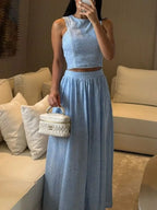 Trendsi eyelet crop top and maxi skirt set in white, featuring a stylish crop top with eyelet details and a flowing maxi skirt.