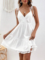 Backless cotton surplice summer mini dress with tassel hem, trendy dress by Trendsi featuring a stylish design.