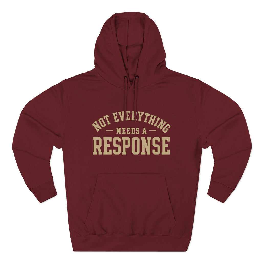 Black "Not Everything Needs a Response" hoodie by Wear Your Worship from the SEEN. Identity Line, featuring bold white text on the front.