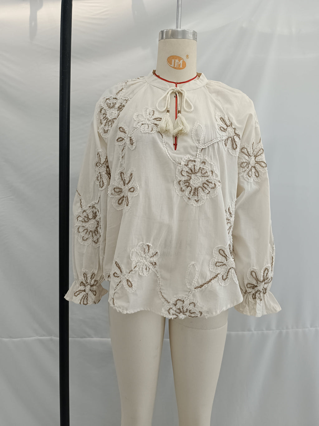 Women’s spring floral embroidered mini shirt by Bella Mia, featuring sweet pastel colors and delicate floral embroidery.