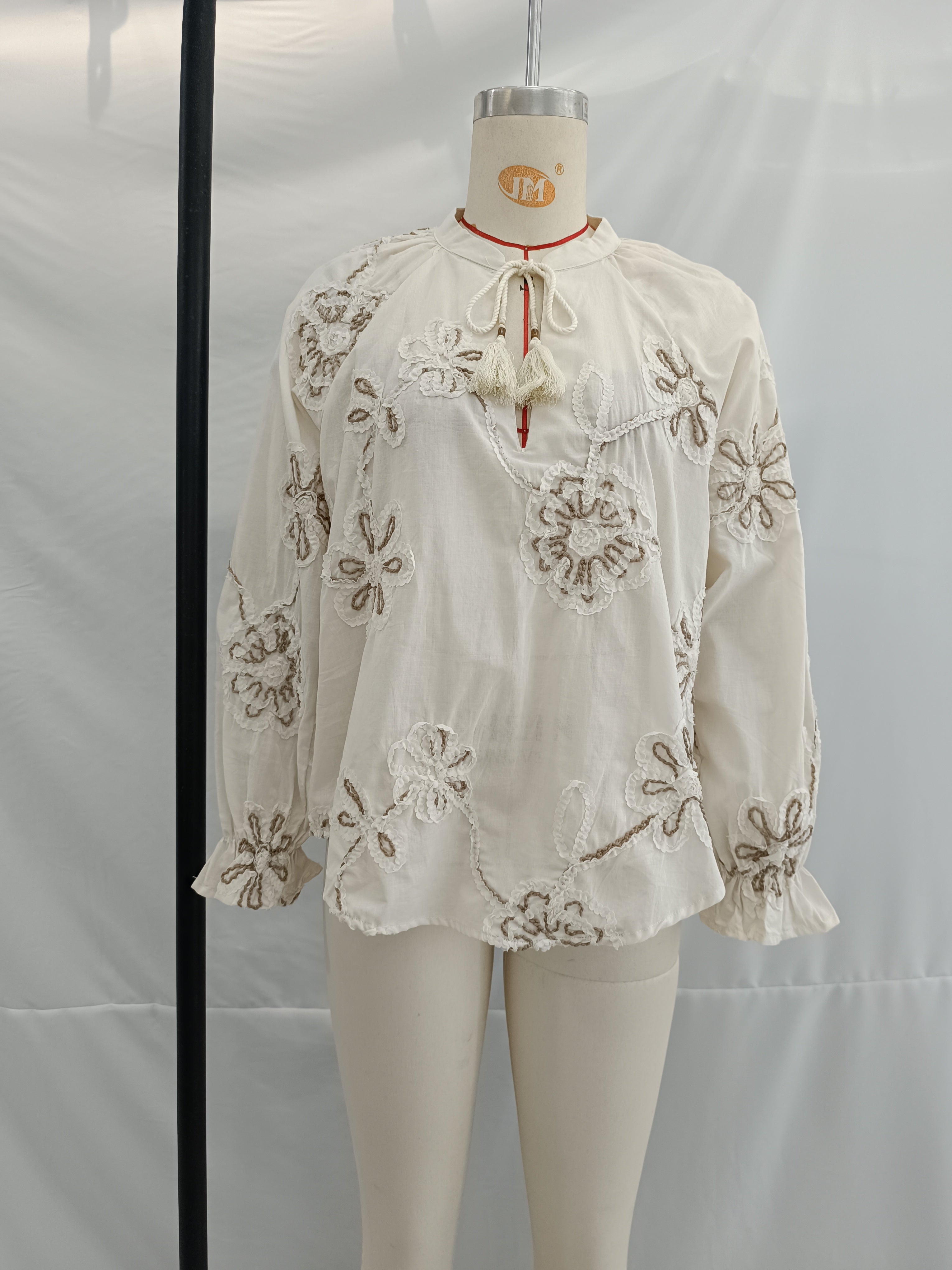 Women’s spring floral embroidered mini shirt by Bella Mia, featuring sweet pastel colors and delicate floral embroidery.