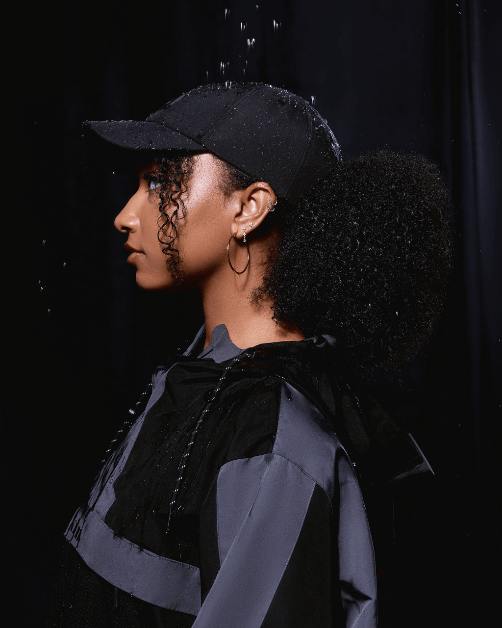 Black waterproof satin-lined dad hat with curved brim and adjustable strap, designed for style and weather protection.