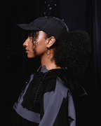 Black waterproof satin-lined dad hat with curved brim and adjustable strap, designed for style and weather protection.