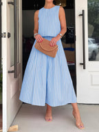 Women's striped sleeveless top and midi skirt two-piece set by Trendsi, featuring a stylish, coordinated summer outfit.