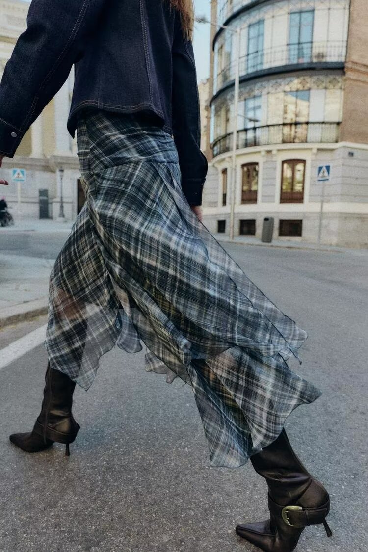 Women’s autumn plaid mid-waist asymmetric skirt, featuring an irregular design, from Wanita Store.