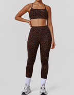 Leopard print high-waist yoga pants and matching fitness bra set by Bella Mia, designed for exercise and active wear.