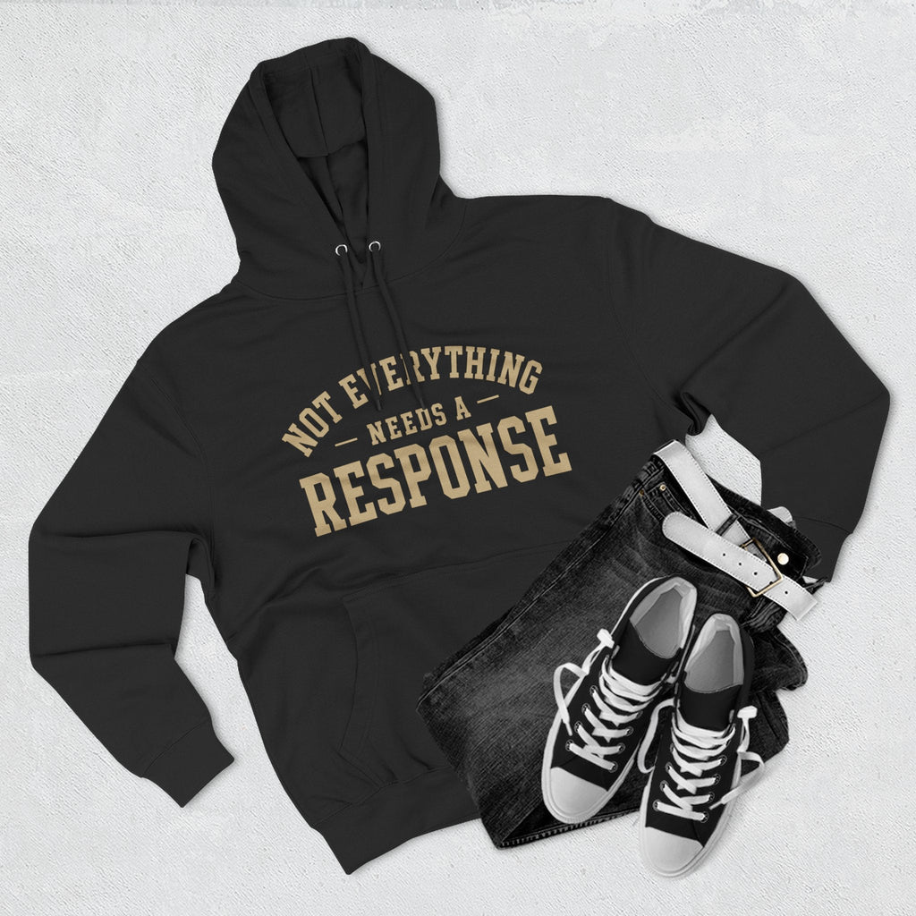 Black "Not Everything Needs a Response" hoodie by Wear Your Worship from the SEEN. Identity Line, featuring bold white text on the front.