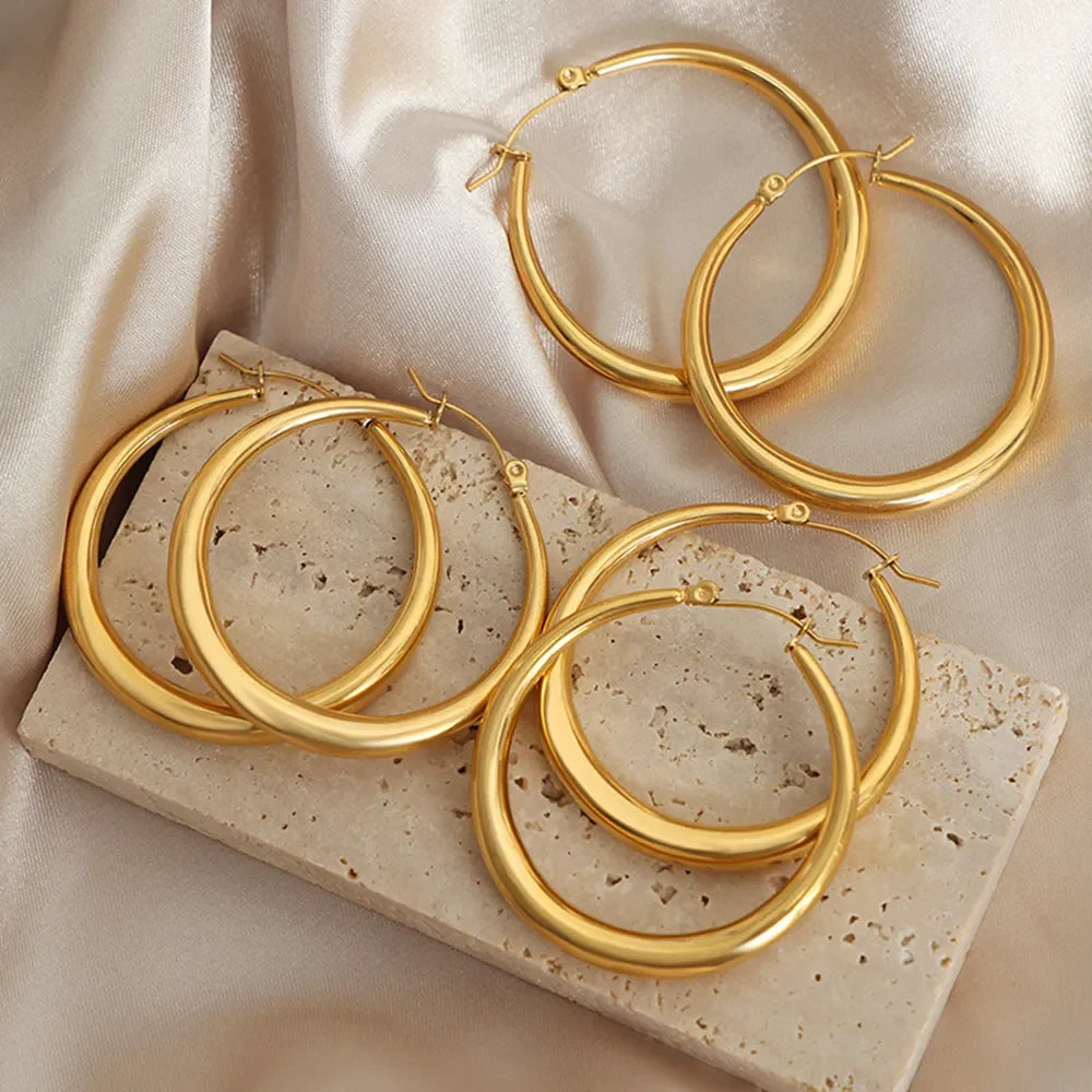 18K gold-plated hoop earrings by Shopimist, medium-sized, shiny circular jewelry with smooth finish on a white background.