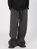 Men's plaid wide-leg casual pants with drawstring waist by Trendsi, featuring a relaxed fit and stylish plaid pattern.