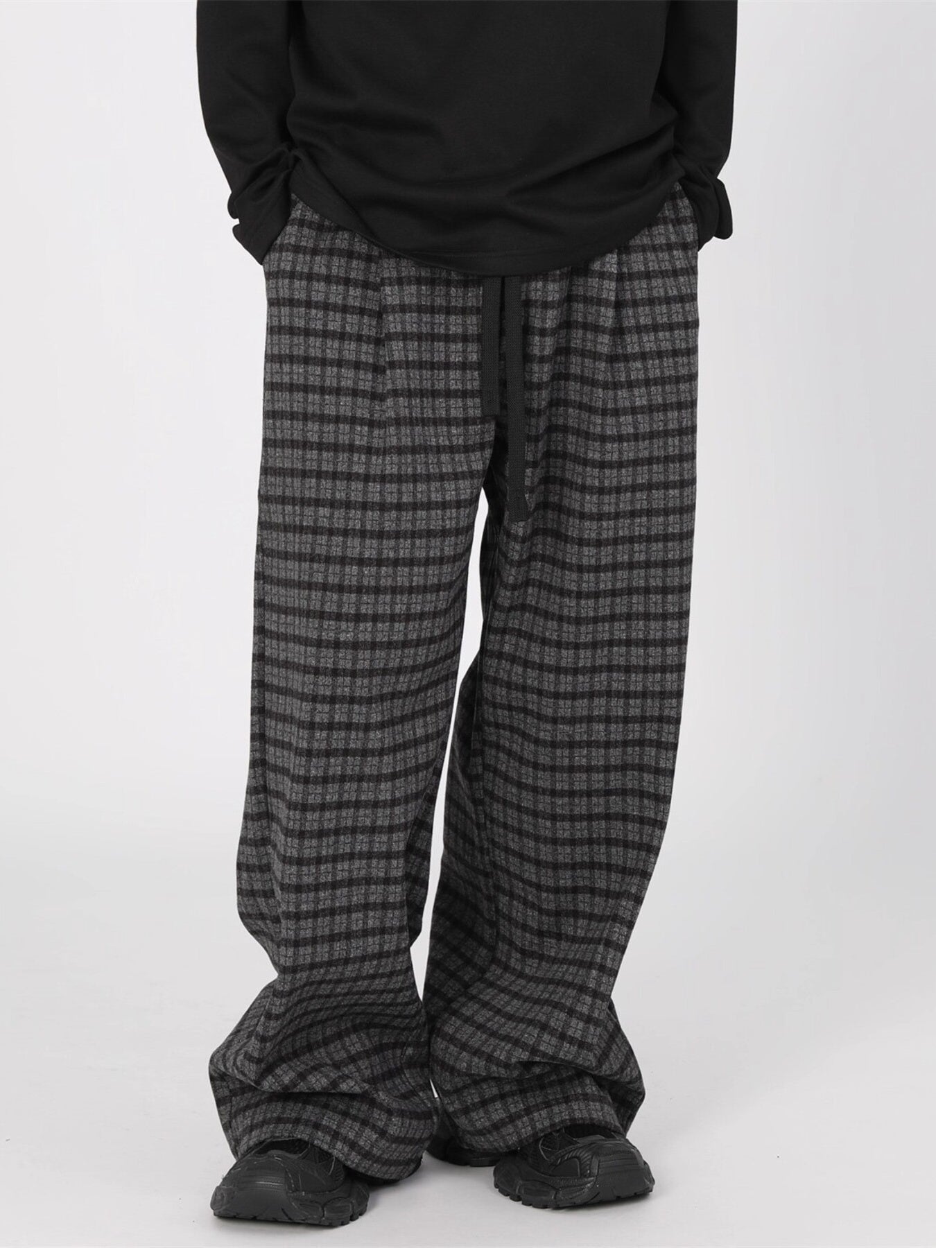 Men's plaid wide-leg casual pants with drawstring waist by Trendsi, featuring a relaxed fit and stylish plaid pattern.