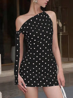 Polka dot sleeveless mini dress with bow accents by Shopimist, featuring a fitted silhouette and playful pattern.