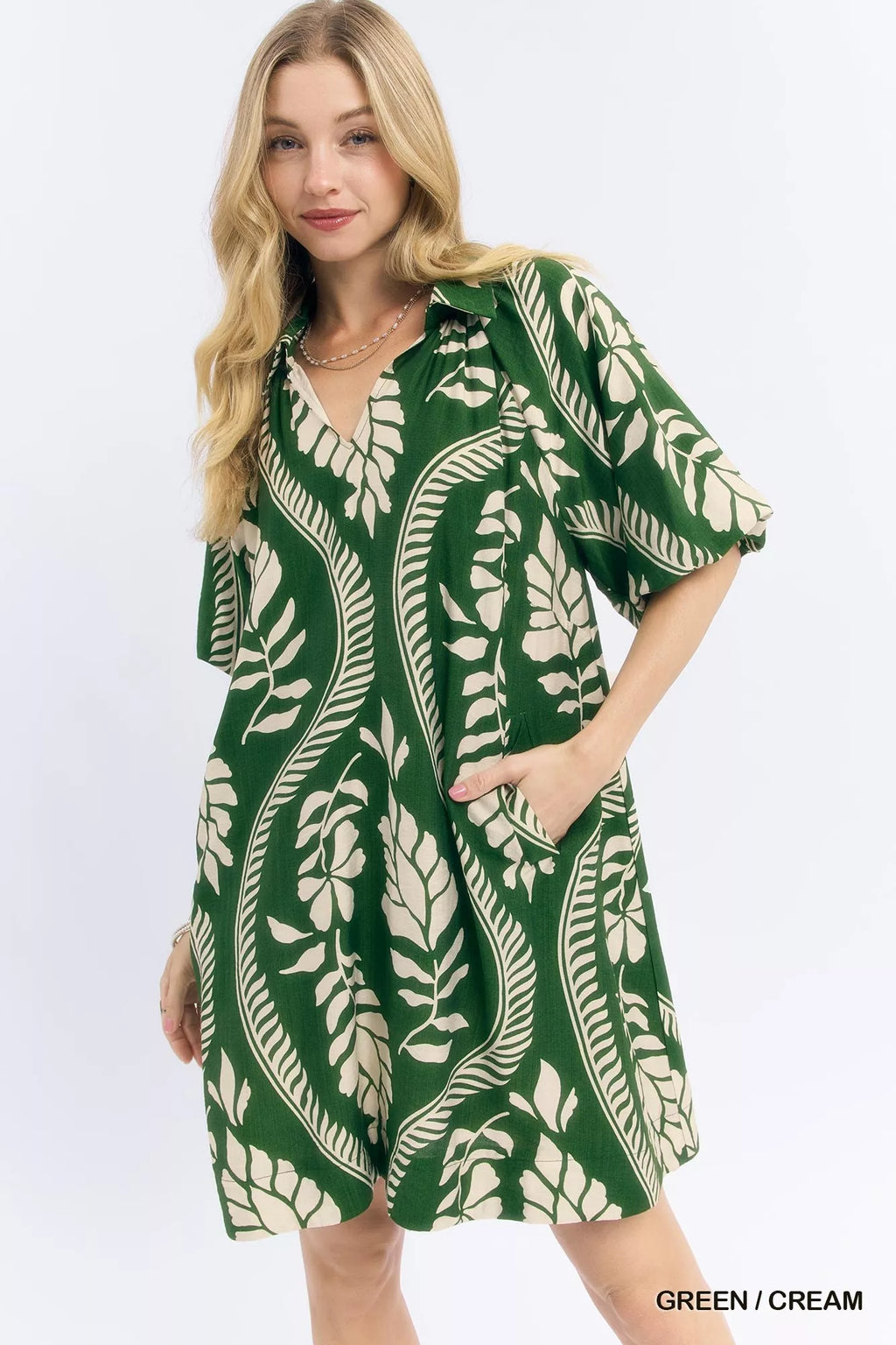 Umgee leafy ogee print mini dress featuring a flowy silhouette and vibrant green and white pattern.