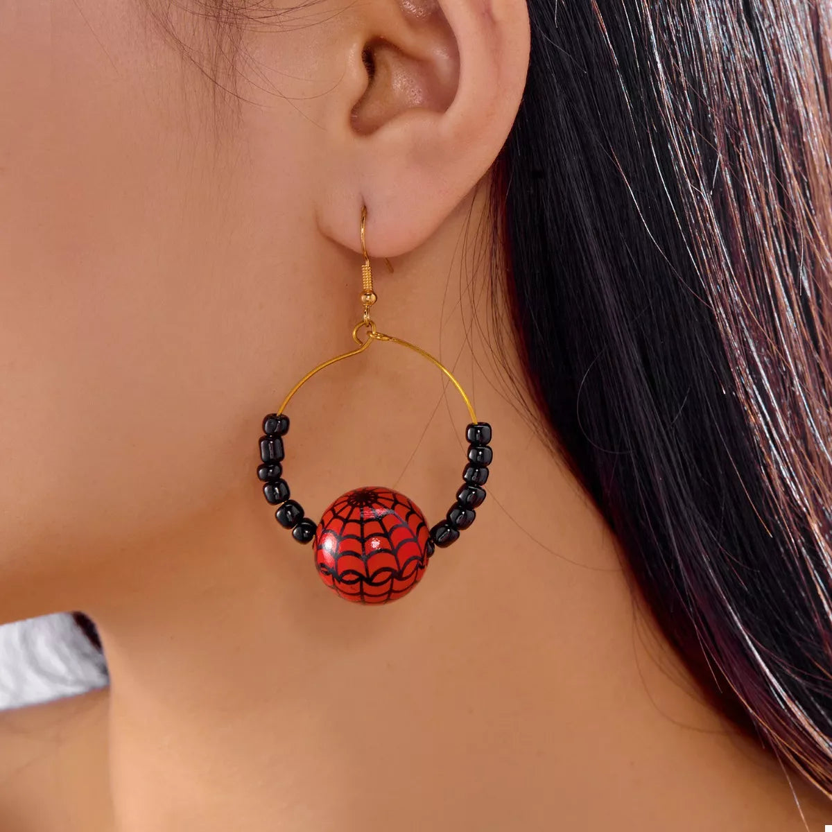 Gold-plated Halloween bead earrings with spooky charm, featuring black and orange beads, by Plush Fashion Hub.