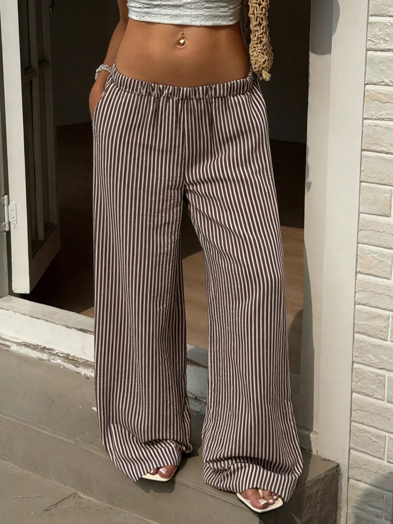 Plush Fashion Hub tied striped wide-leg pants featuring comfortable, stylish bottoms with a relaxed fit and bold stripe pattern.