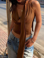 Elegant satin-feel sleeveless blouse with cowl neck and ruched details, perfect for versatile styling.