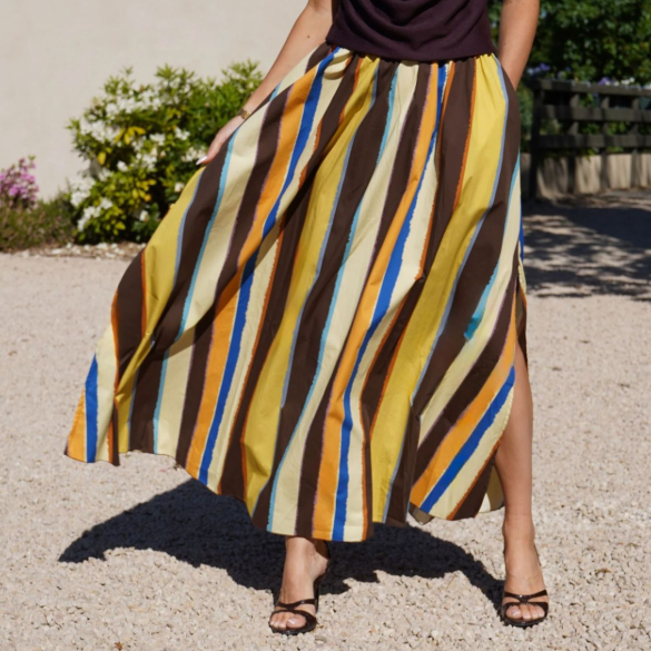 Elegant women's striped printed skirt with slit hemline from Plush Fashion Hub, featuring colorful vertical stripes and a stylish design.