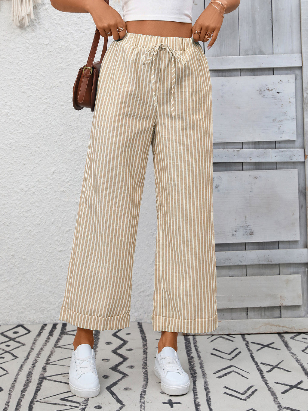 Women's striped wide-leg drawstring pants with pockets, stylish and comfortable from Trendsi, shown in a relaxed fit.