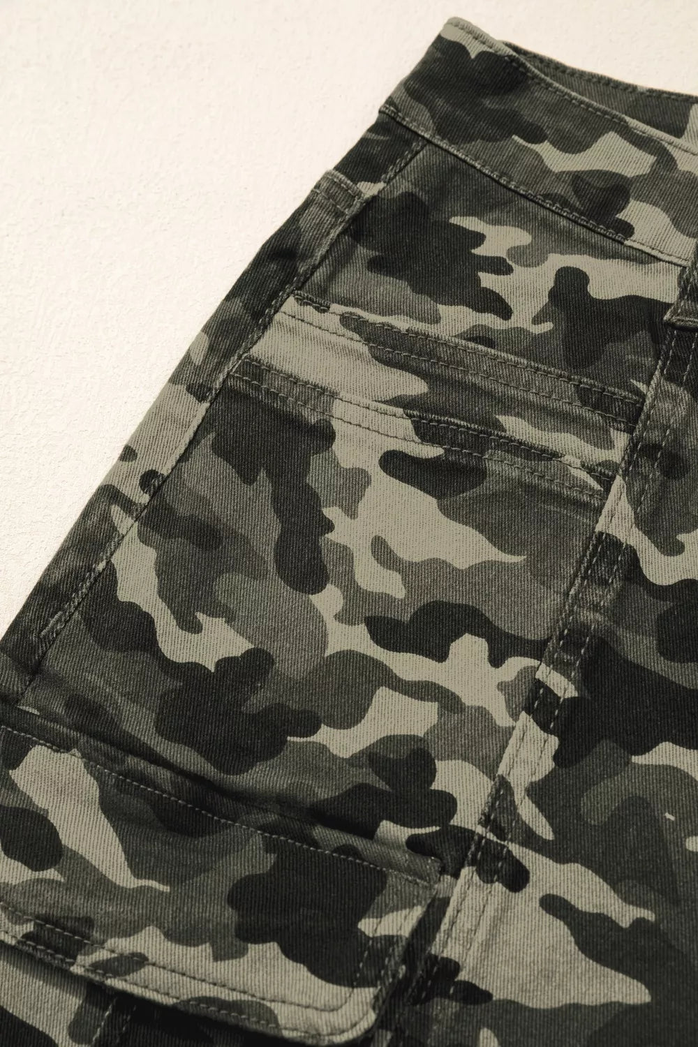 Camouflage print women's denim pants with multiple pockets, stylish and functional, by Shopimist.