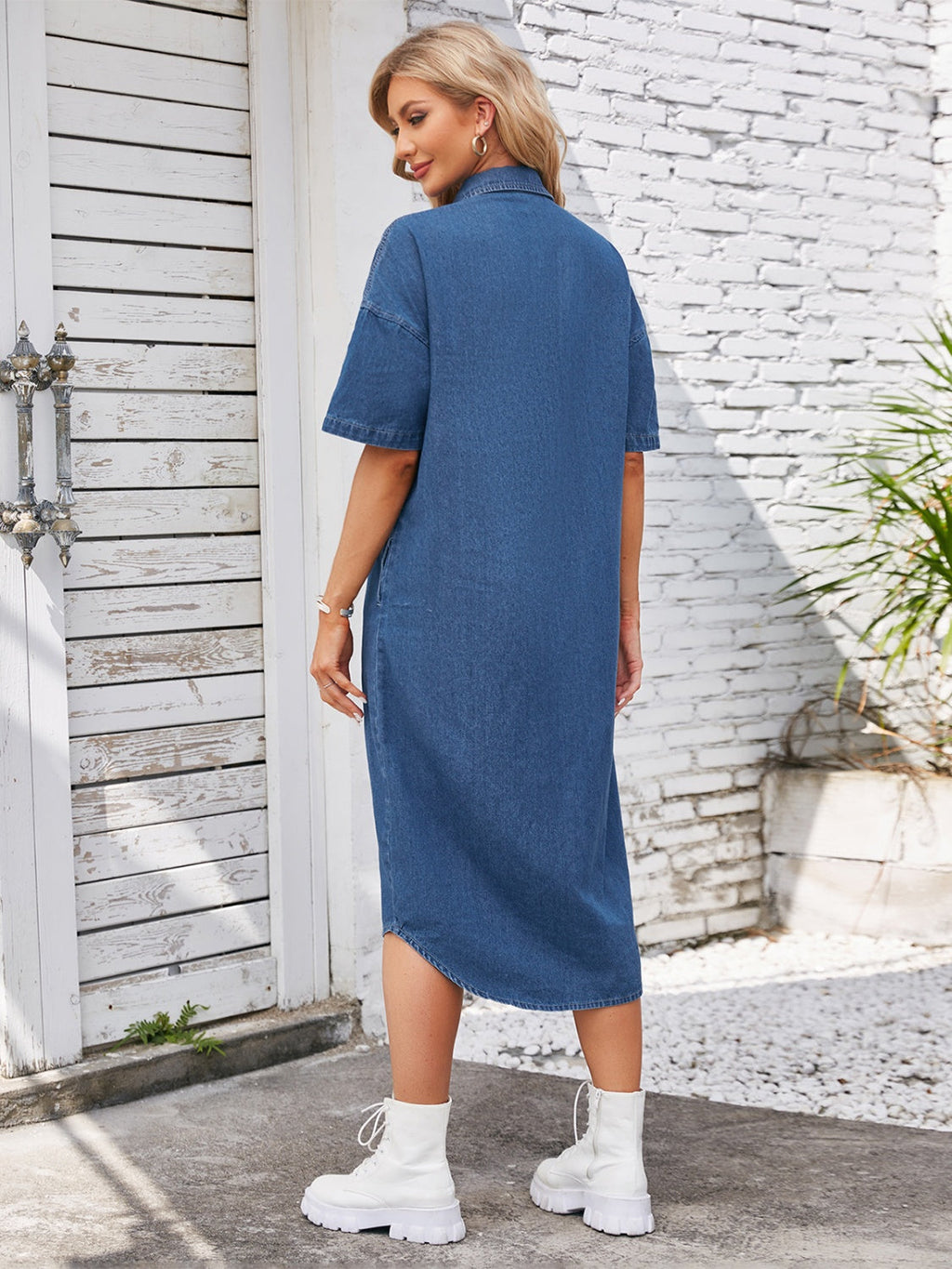 VYSN button-up dropped shoulder denim dress hanging on a hanger, showcasing its casual style and classic denim fabric.