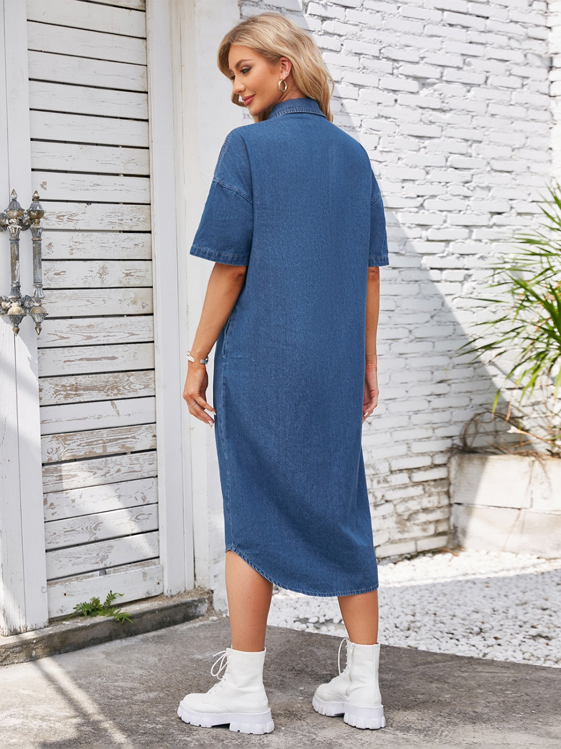 VYSN button-up dropped shoulder denim dress hanging on a hanger, showcasing its casual style and classic denim fabric.