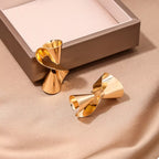 18K gold-plated twist earrings with a sleek, modern design, featuring a smooth and shiny finish.
