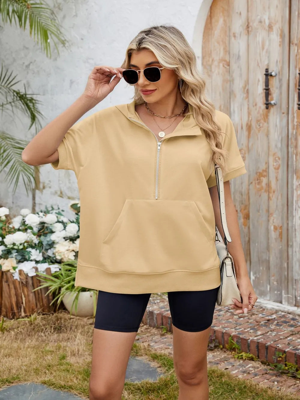 Half zip short sleeve hooded top from Trendsi, featuring a casual fit, lightweight fabric, and a stylish hood with a zip front.