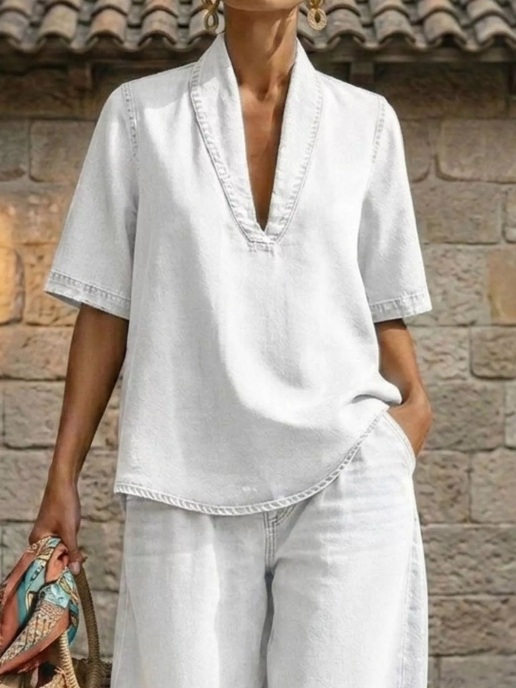 Plus size women's dress set featuring a half sleeve top and wide-leg pants, stylish and comfortable by Trendsi.