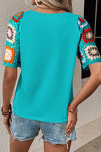 Geometric print round neck short sleeve blouse from Plush Fashion Hub, featuring a stylish design and vibrant pattern.