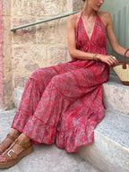Tiered halter neck maxi dress by Trendsi featuring flowing fabric and a stylish tiered design, perfect for summer or special occasions.