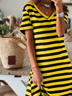 Plus size full-length striped V-neck midi dress with side slit, trendy fashion by Trendsi, perfect for casual or dressy occasions.