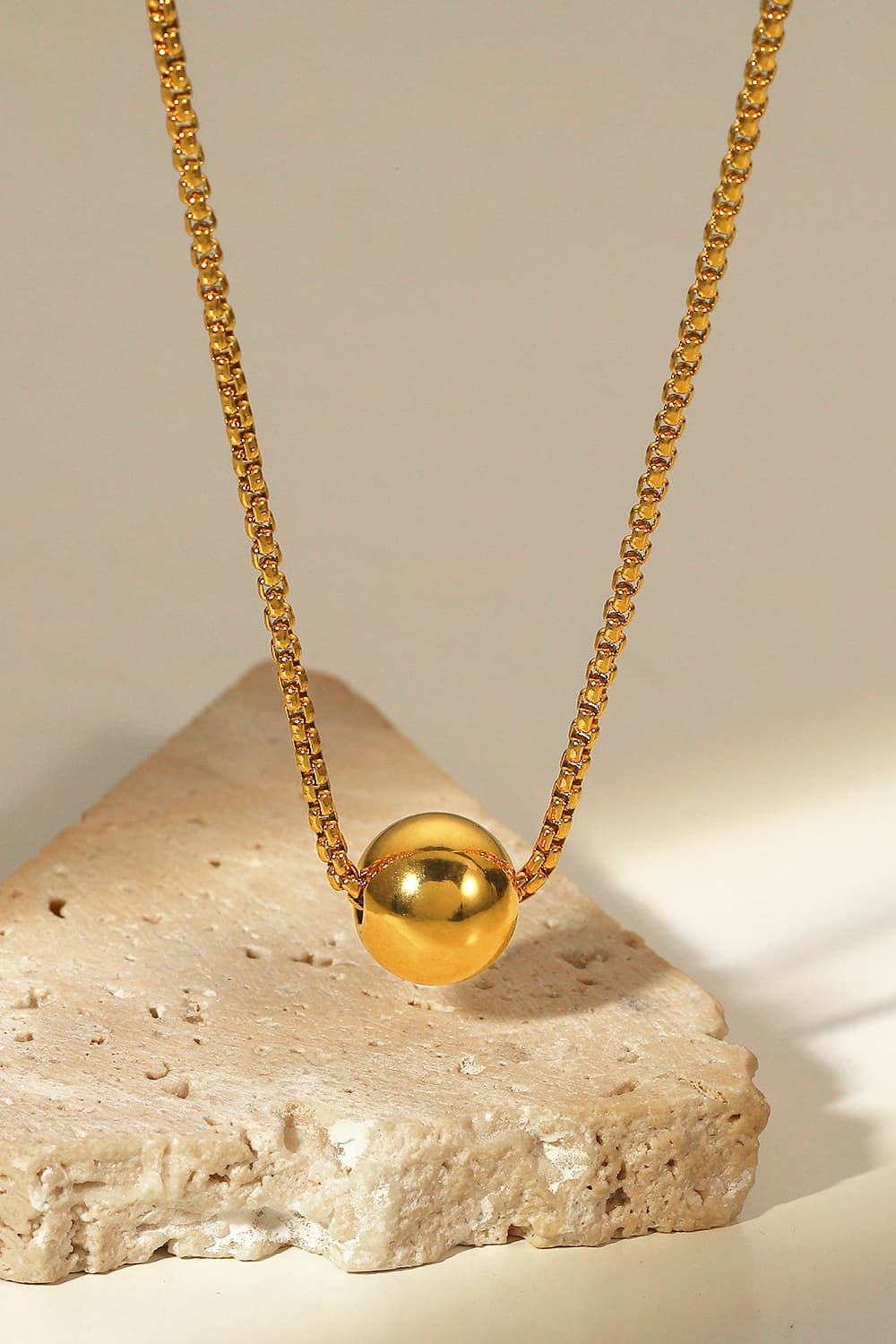 18K gold-plated round pendant necklace with a delicate chain, featuring a polished circular charm on a sleek jewelry chain.