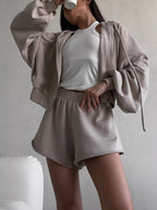 Trendsi zip-up long sleeve outerwear and matching shorts set, casual athletic style, shown on a model in a neutral setting.