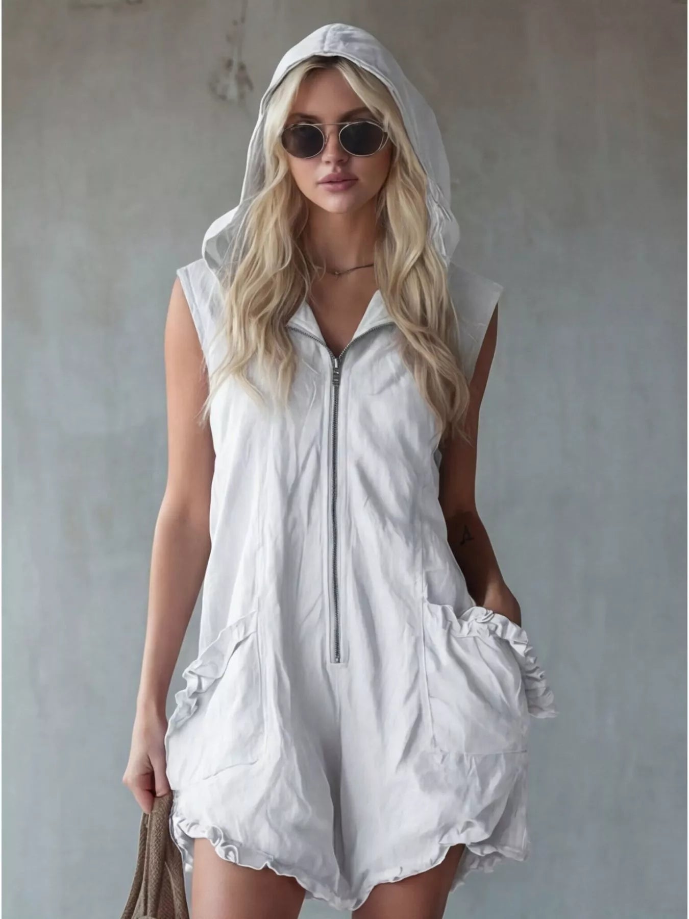 Plus size sleeveless hooded zipper romper with ruffled pockets by Plush Fashion Hub, showing the front view and ruffle details.