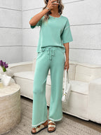 Women's casual two-piece lounge set with round neck top and drawstring pants, stylish and comfortable for relaxed wear.