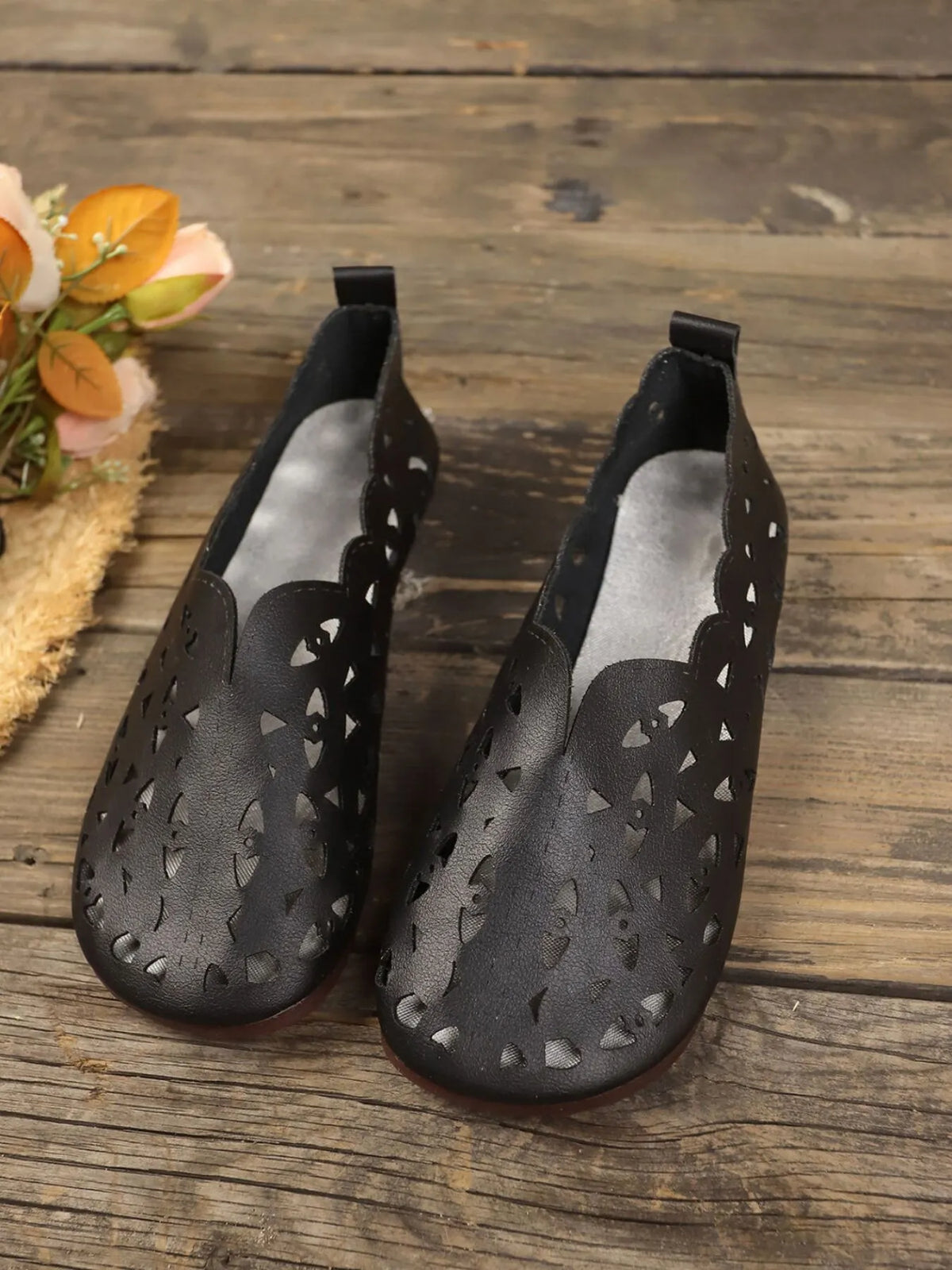 Perforated leather slip-on loafers by Trendsi, stylish footwear with breathable design and sleek black finish.