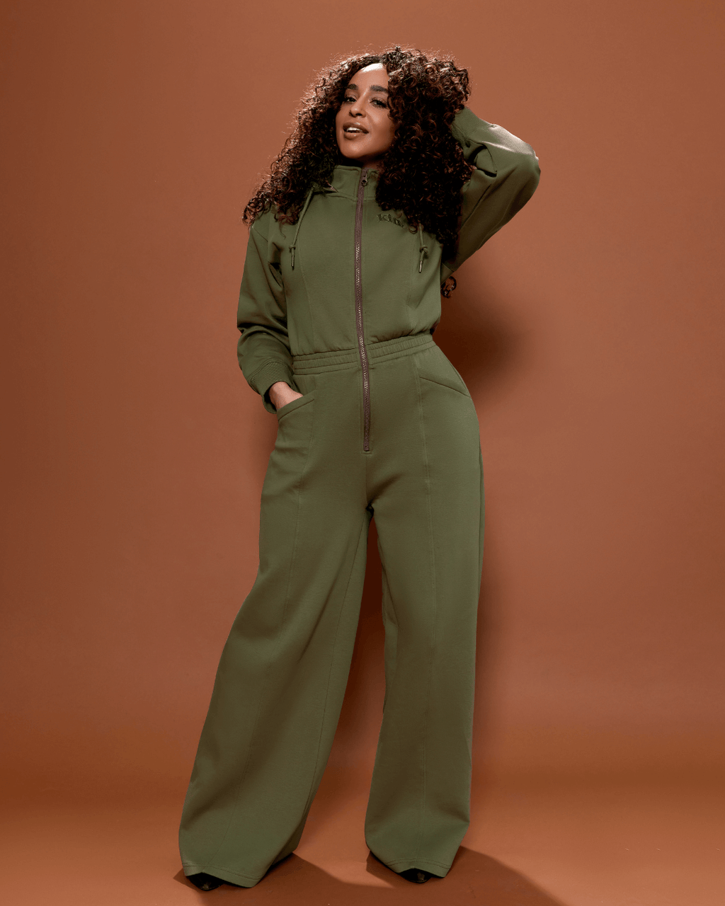 Green satin-lined jumpsuit from Plush Fashion Hub showcasing a stylish, fitted design with long sleeves and a tapered leg fit.