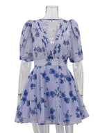 Floral puff sleeve mini dress by Shopimist featuring a fitted waist, vibrant floral pattern, and short puffed sleeves.