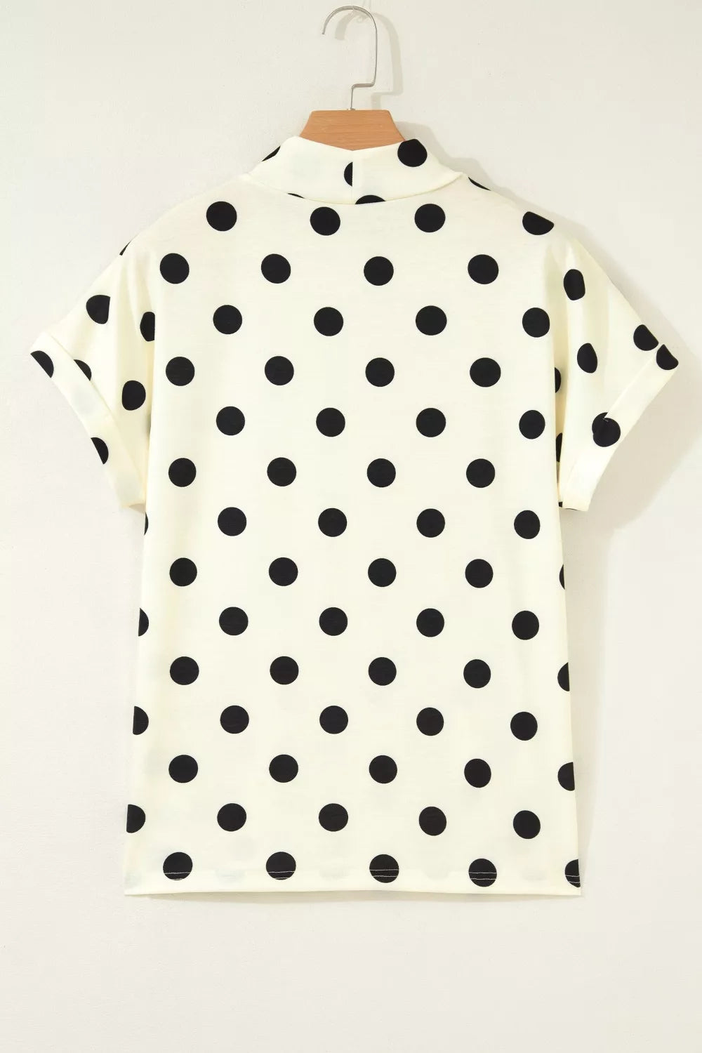 Polka dot print high neck dolman top from Plush Fashion Hub, featuring a relaxed fit and stylish design in a close-up image.