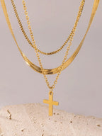 18K gold-plated three-layered cross necklace with intricate chain details, displayed on a neutral background