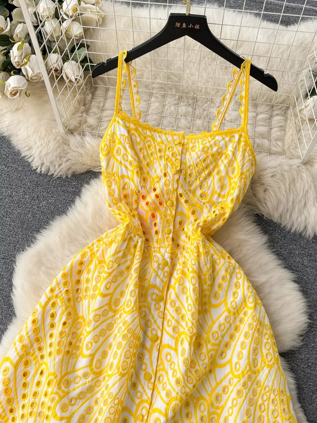 Eyelet embroidered tiered boho midi camisole dress by Trendsi, featuring summer-inspired design and lightweight fabric.