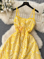 Eyelet embroidered tiered boho midi camisole dress by Trendsi, featuring summer-inspired design and lightweight fabric.