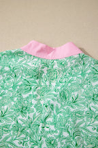 Plush Fashion Hub floral midi dress with contrast trim and flutter sleeves, featuring a feminine, flowy design.