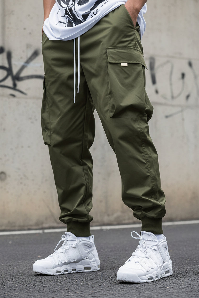 Men’s multi-pocket drawstring cargo pants in streetwear style by Plush Fashion Hub, featuring multiple utility pockets and a relaxed fit.