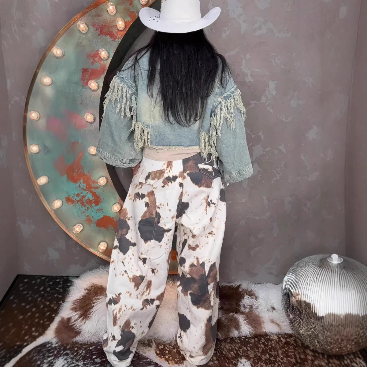 Eprolo Western style jeans featuring cowhide pattern and curved knife design, denim fabric with detailed stitching.