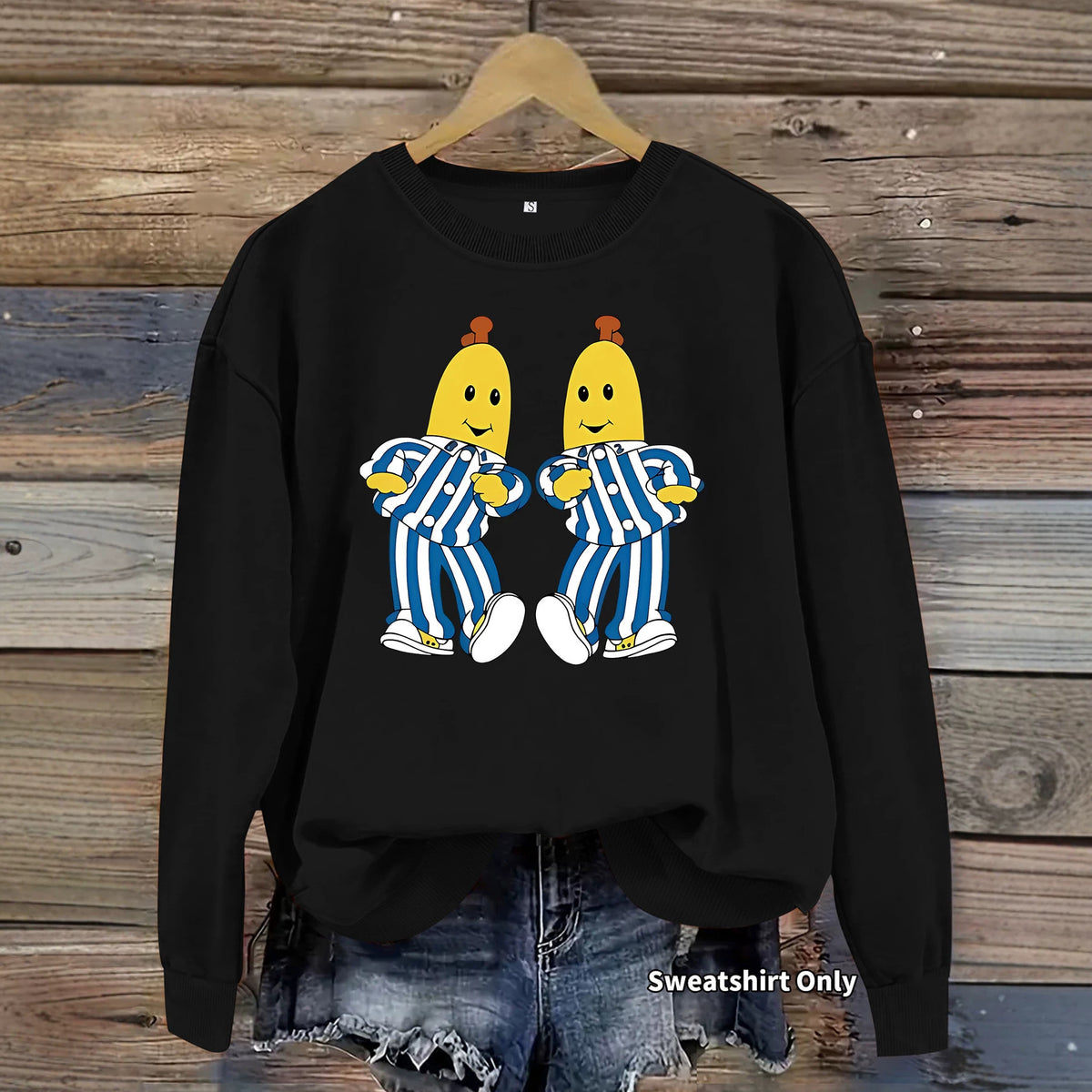 Black cotton sweatshirt featuring a graphic of two Bananas in Pyjamas in blue and white striped pajamas.