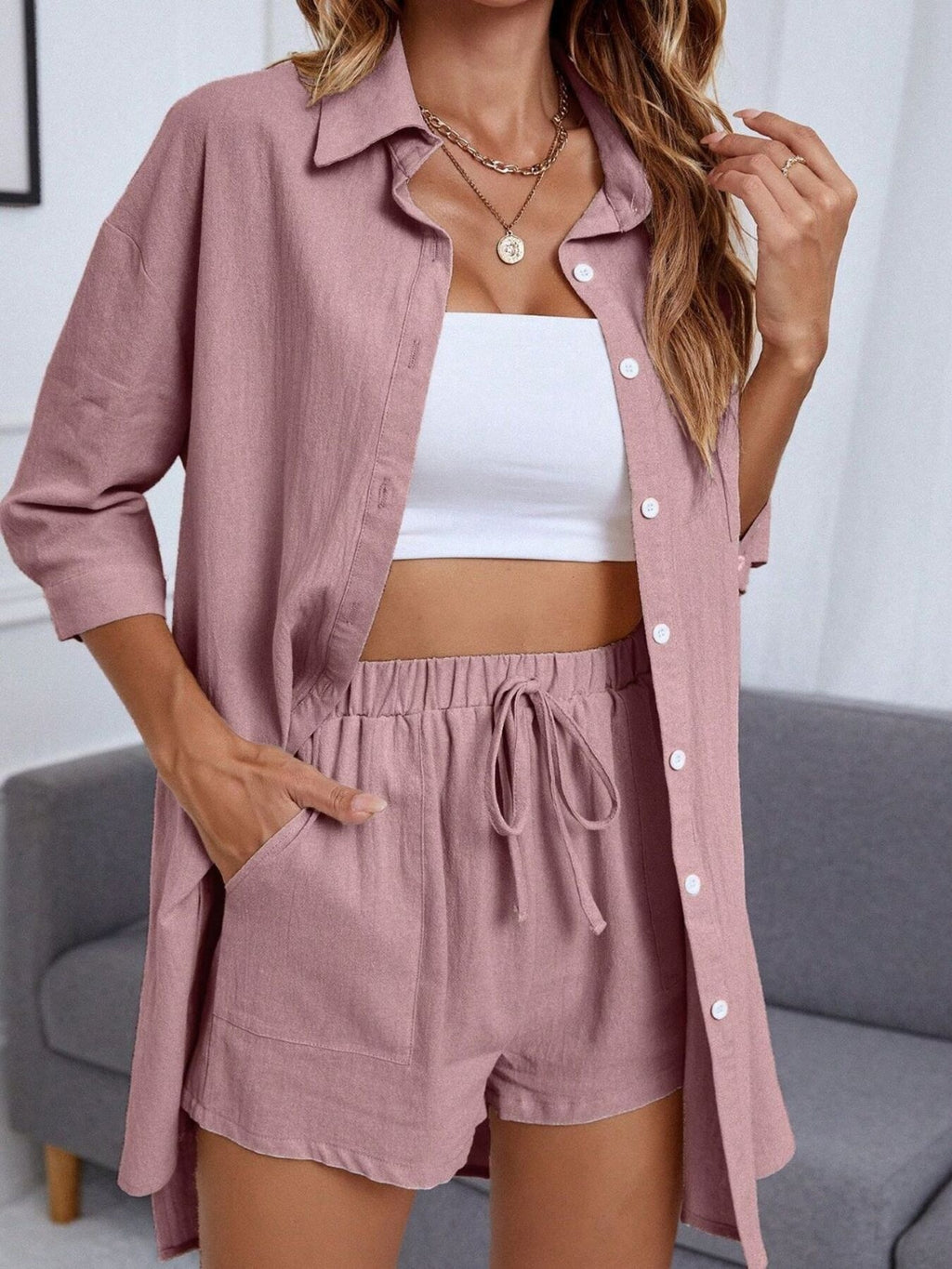 Women's casual button-up shirt and shorts two-piece set by Trendsi, featuring a relaxed fit and stylish design.