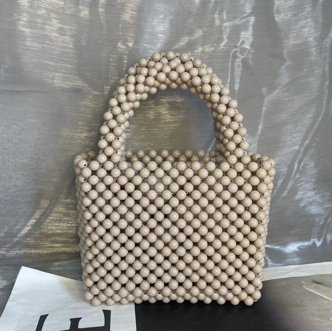 Eprolo beaded handbag with solid color design, featuring intricate beadwork and a stylish hand strap.