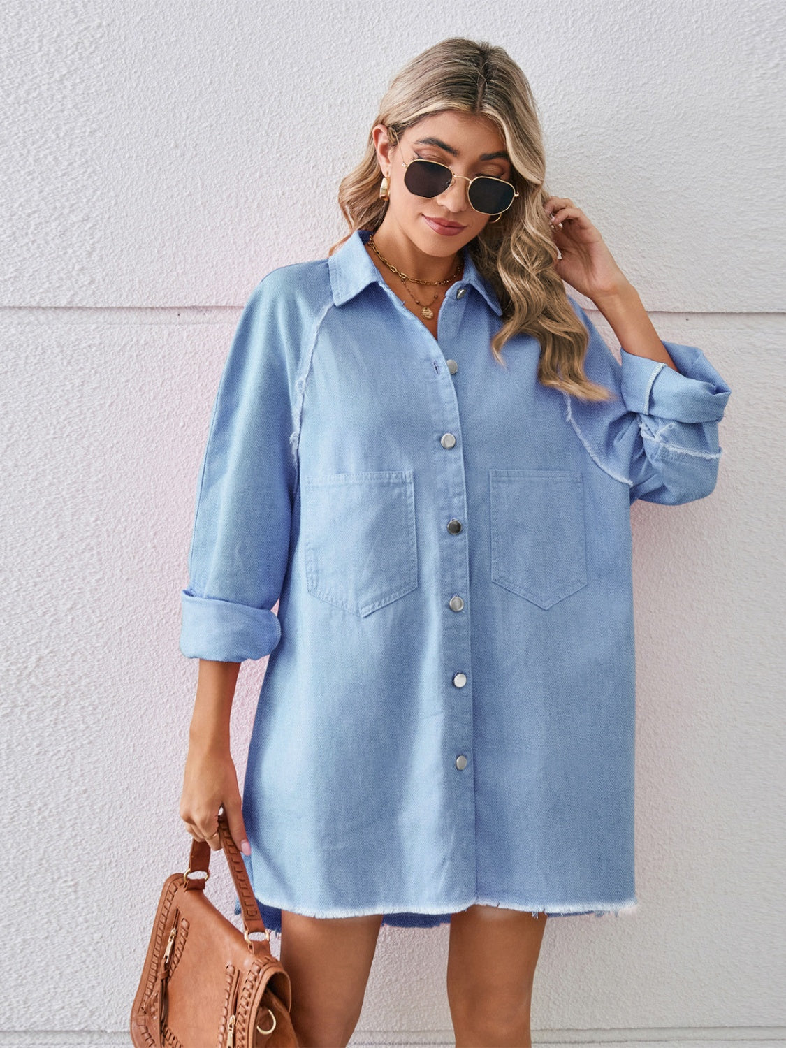 VYSN raw hem button-up denim dress featuring a classic collar, long sleeves, and a relaxed fit for casual style.
